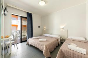 Posteľ alebo postele v izbe v ubytovaní Hotel La Siesta