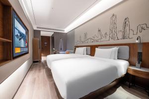 Postel nebo postele na pokoji v ubytování UrCove by Hyatt Shenzhen Bay Nanyou