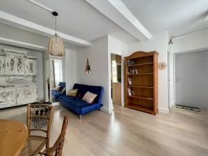 a living room with a blue couch and a table at Fun x Cosy City Retreat by Melrose in Bayeux +22 photos
