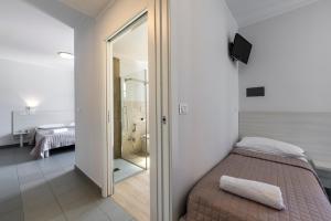 Posteľ alebo postele v izbe v ubytovaní Hotel La Siesta