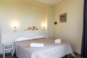 Posteľ alebo postele v izbe v ubytovaní Hotel La Siesta