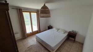 a bedroom with a bed and a window at Belle maison spacieuse proximité mer in Le Crotoy