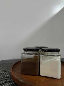two glass jars sitting on a wooden tray at Amani Grand Citygate in Pampanga