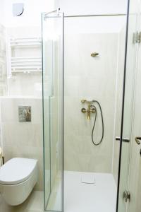 a glass shower door in a bathroom with a toilet at Vila Roxana Eforie Nord in Eforie Nord