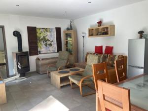 a living room filled with furniture and a refrigerator at Bungalov v Krásné Lípě in Krásná Lípa