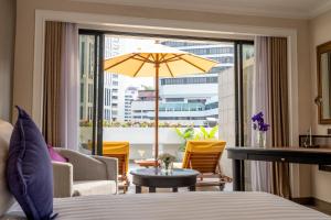 a hotel room with a bed and a large window at NH Bangkok Sukhumvit Boulevard in Bangkok +67 photos
