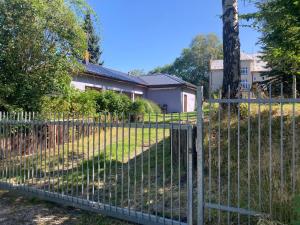 a fence in front of a house at Bungalov v Krásné Lípě in Krásná Lípa