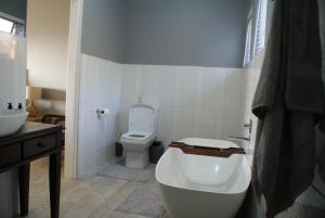 a bathroom with a tub and a toilet and a sink at Sea Vista in Pennington +22 photos