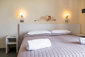 Posteľ alebo postele v izbe v ubytovaní Hotel La Siesta