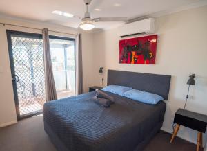 a bedroom with a bed with a purse on it at Jurien Bay Tourist Park in Jurien Bay