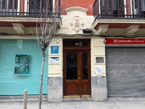 a building with a wooden door on a street at GETXO ROOMS in Getxo