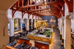 a view of the dining hall of a restaurant at Post-Plaza Hotel & Grand Café in Leeuwarden