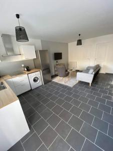 a room with a kitchen and a living room at Maison à 300m de la mer avec 2 chambres in Lion-sur-Mer