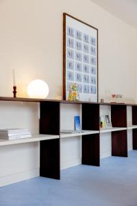 a desk with shelves and a mirror in a room at Confort et calme à moins de 2h de Paris in Boudernault +28 photos