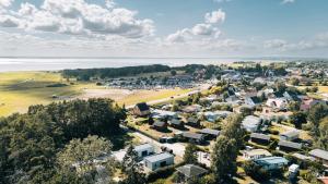 an aerial view of a small town next to the water at Ferienhaus Küstennebel - Ostseewelle mit Sauna in Ostseebad Koserow