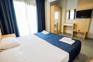 Postel nebo postele na pokoji v ubytování M2 Hotel