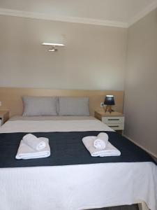 Postel nebo postele na pokoji v ubytování M2 Hotel
