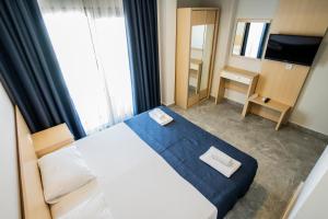 Postel nebo postele na pokoji v ubytování M2 Hotel