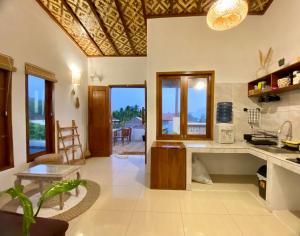 a kitchen with a table and a counter top at Sackstone rooftop villa in Watukarung