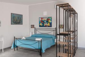 a bedroom with a bed and a spiral staircase at Casa "Stella" - Locazioni Turistiche in Pulsano +58 photos