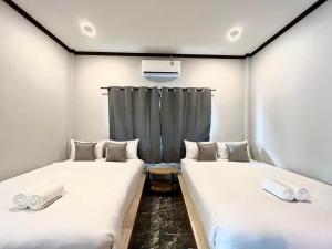 Postel nebo postele na pokoji v ubytování Baankao Resort Rayong