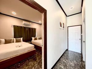 Postel nebo postele na pokoji v ubytování Baankao Resort Rayong