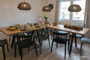 a dining room table with chairs and fruits on it at Sali Homes - Bergerie in Obersulm