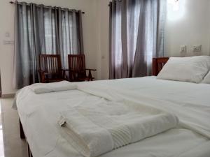 CHAEL Airport Residency,Nedumbassery Cochin客房内的一张或多张床位