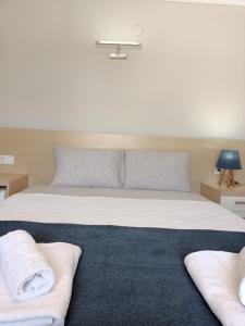 Postel nebo postele na pokoji v ubytování M2 Hotel