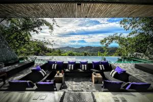 a living room with a couch and a swimming pool at Z VILLA InstaDream Luxury 180 Sea & Sunset in Ban Taling Ngam