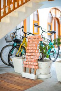 a staircase with a sign with bikes parked next to it at Yulaman Hotel in Gili Trawangan