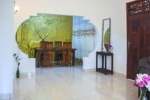 a living room with a painting on the wall at Lakmali Homestay in Watagederamulla