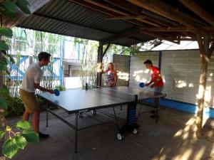 a group of people standing around a ping pong table at Ferienzimmer KAI mit Fahrradverleih in Zinnowitz
