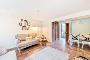 a living room with a couch and a table at Woodcutter's Cottage in Dorchester