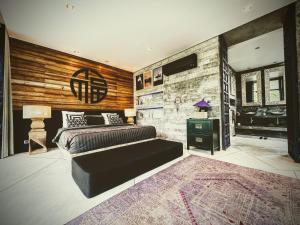 a bedroom with a large bed and a stone wall at Z VILLA InstaDream Luxury 180 Sea & Sunset in Ban Taling Ngam