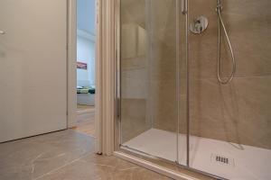 a shower with a glass door in a bathroom at Accursio Boutique House in Milan +12 photos