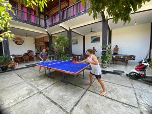 a woman playing ping pong on a ping pong table at Sackstone rooftop villa in Watukarung