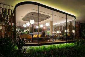 a living room with a large glass wall at Viroth's Hotel in Siem Reap