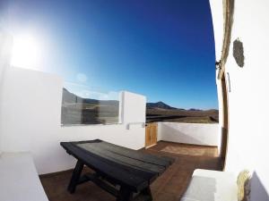 a room with a bench and a view of the desert at La Carpintería nature relax in Tefía