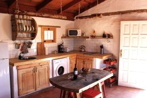 a kitchen with a washer and a table in it at La Carpintería nature relax in Tefía