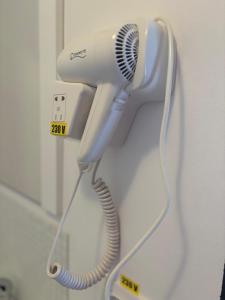 a hair dryer is hanging on a wall at Casa Mocanitei in Vişeu de Sus
