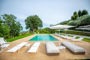 a pool with white lounge chairs and an umbrella at A Casa Da Angelo - Country House PrivatePool & AirCO in Grottammare +79 photos