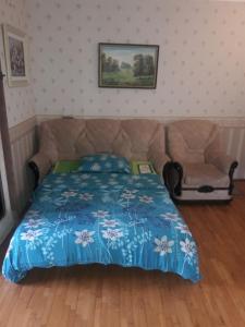 a bedroom with a bed and a chair at Центр Вінниці-Архітектора Артинова 55 Світло є завжди in Vinnytsya
