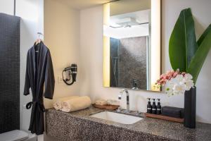 a bathroom with a sink and a mirror at Viroth's Hotel in Siem Reap