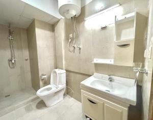 a bathroom with a toilet and a sink at LUXURY Naturale in Kigali +69 photos