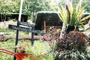 a garden with a sign that says sherlords palace at Shepherd's Ridge Mountain Resort in Marayunot