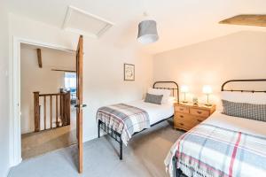 a bedroom with two beds and a mirror at Gamekeeper's Cottage in Dorchester +29 photos