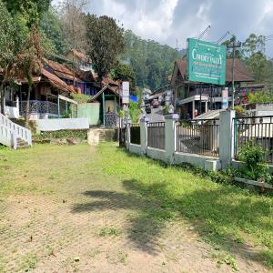 a fence in front of a village with a sign at Pondok Gembyang Ciwidey RedPartner in Ciwidey