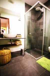 a bathroom with a glass shower and a sink at Flor da Mata in Pipa