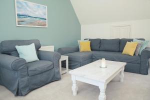a living room with two couches and a coffee table at Divine in Georgeham